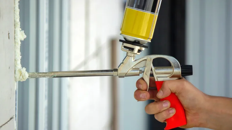 Gun-applied foam sealant closing a gap in the building envelope