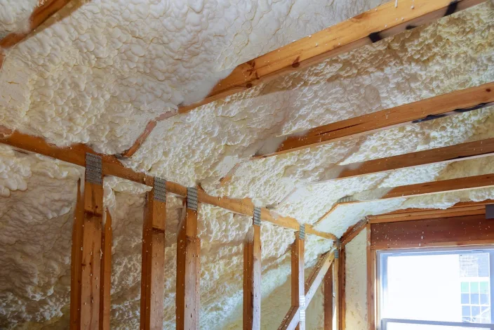 Attic room insulated at the roofline with open-cell foam